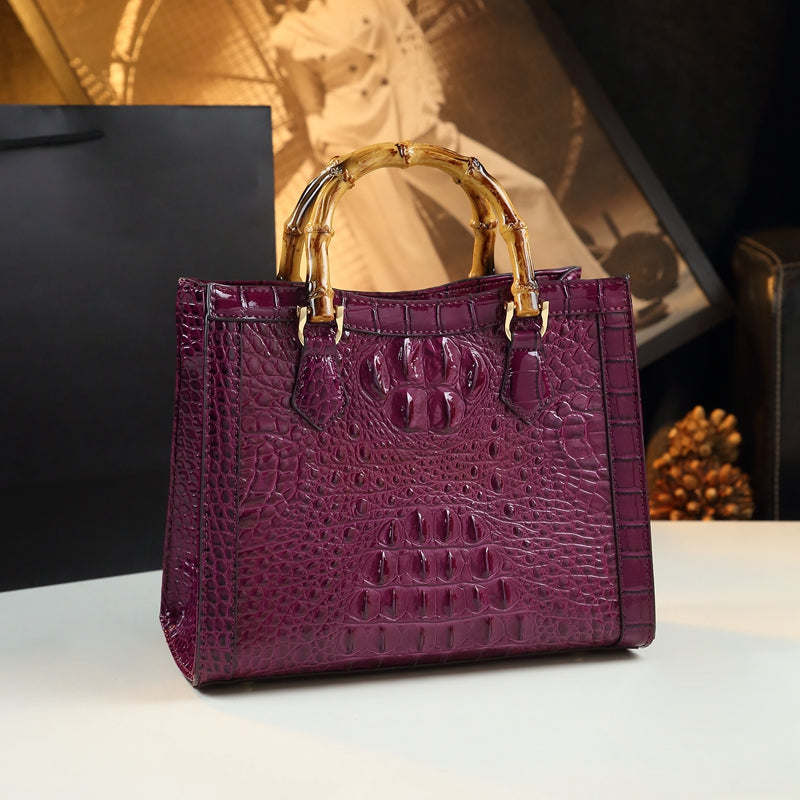 Chic women's accessory: genuine leather crocodile-pattern purse with elegant bamboo top handle.