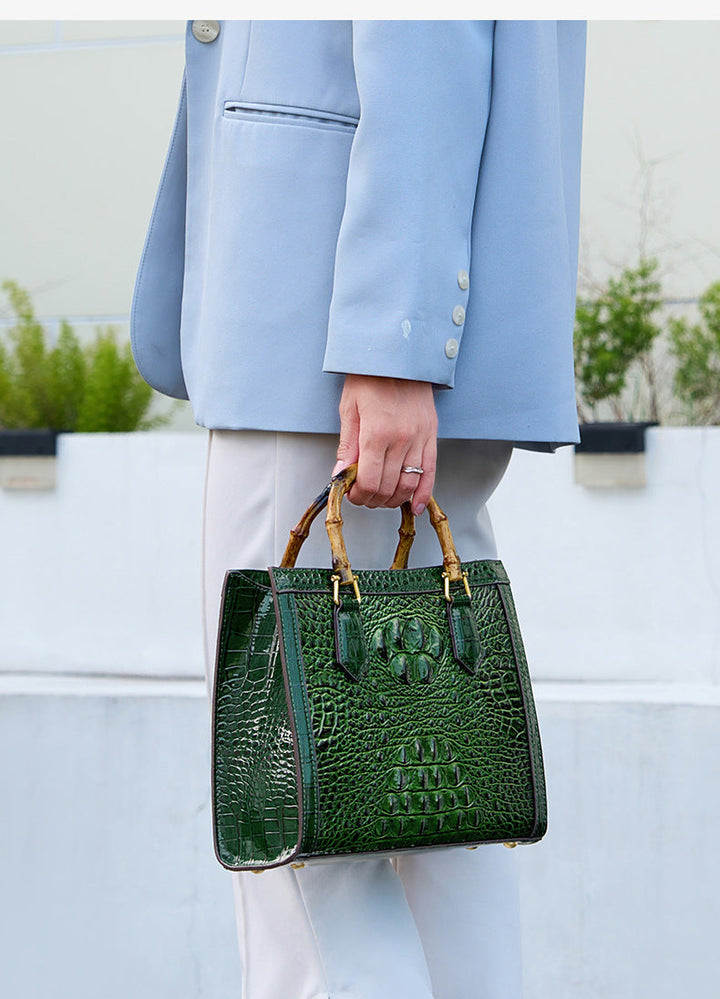 Genuine leather women's bag featuring a stunning crocodile pattern and unique bamboo handle. Luxury look.