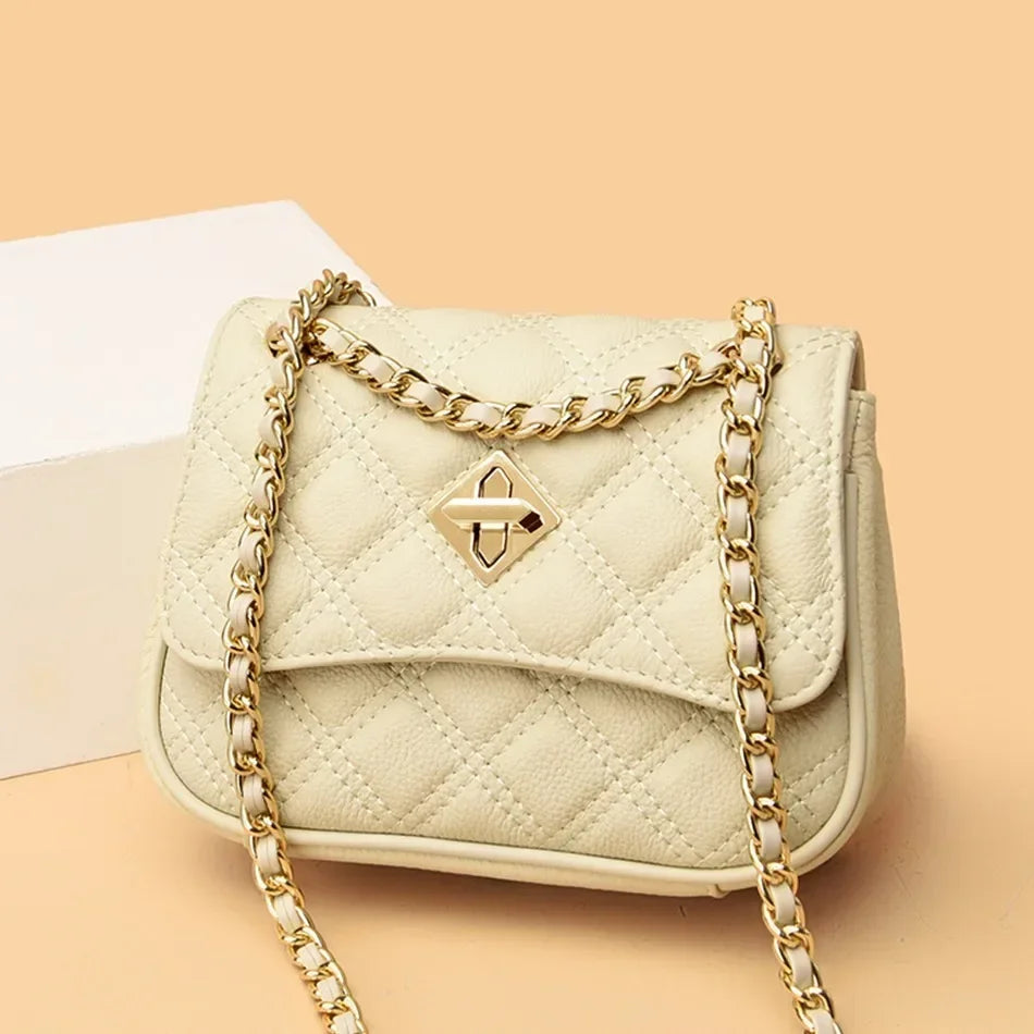 Elegant women's genuine leather quilted shoulder bag featuring a secure twist lock closure. Luxury compact design.