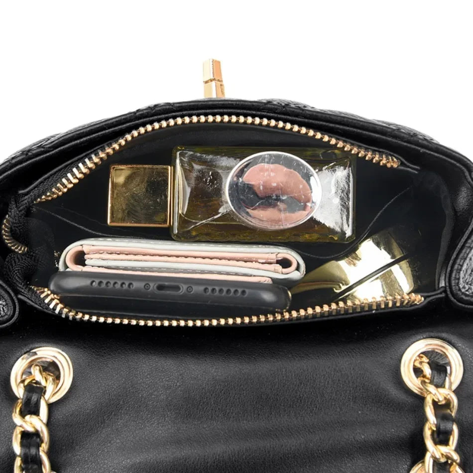 Genuine leather quilted women's handbag with elegant chain strap and twist lock. A luxurious compact shoulder bag.
