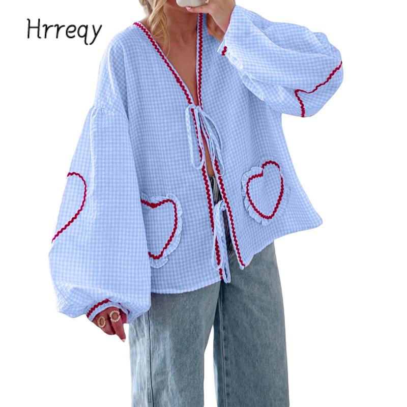 Women's gingham heart blouse with a stylish tie-front and voluminous sleeves, perfect for spring fashion.