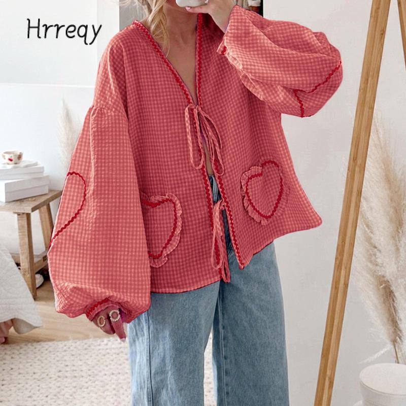 Ladies' fashion blouse in gingham with cute heart appliques, a trendy tie-front, and comfortable voluminous sleeves.