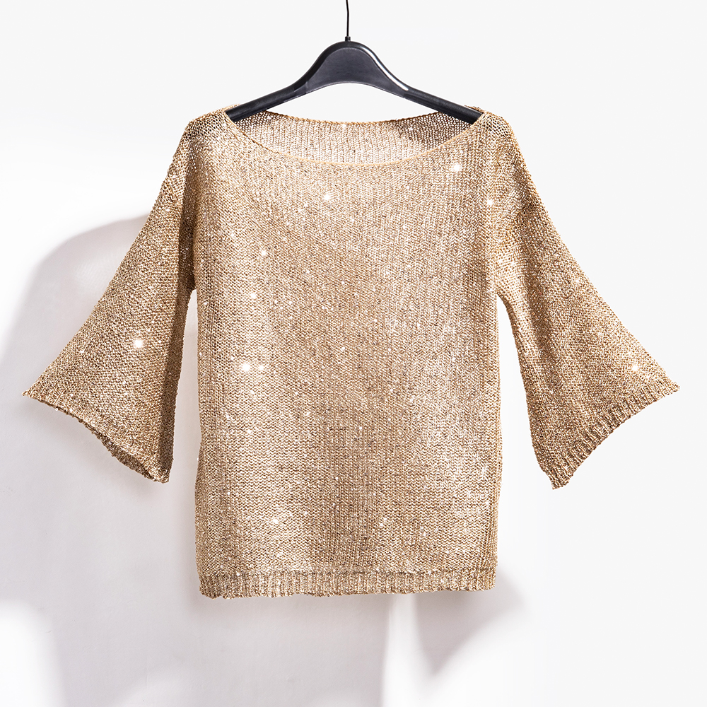 Elegant sequin knit sweater for women. Shimmering long sleeve party top, a glamorous choice for evening events.
