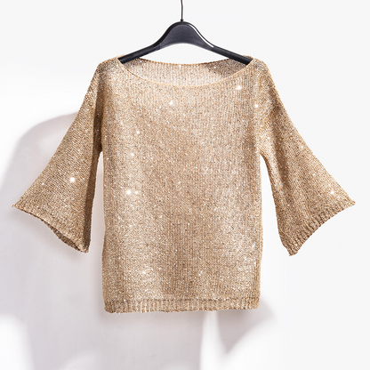 Elegant sequin knit sweater for women. Shimmering long sleeve party top, a glamorous choice for evening events.