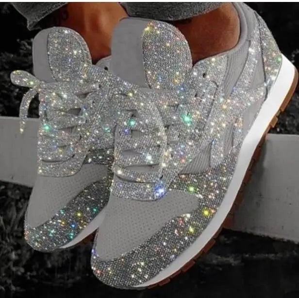 Close-up of women's fashion glitter sneakers featuring white laces, comfortable design for casual street style.