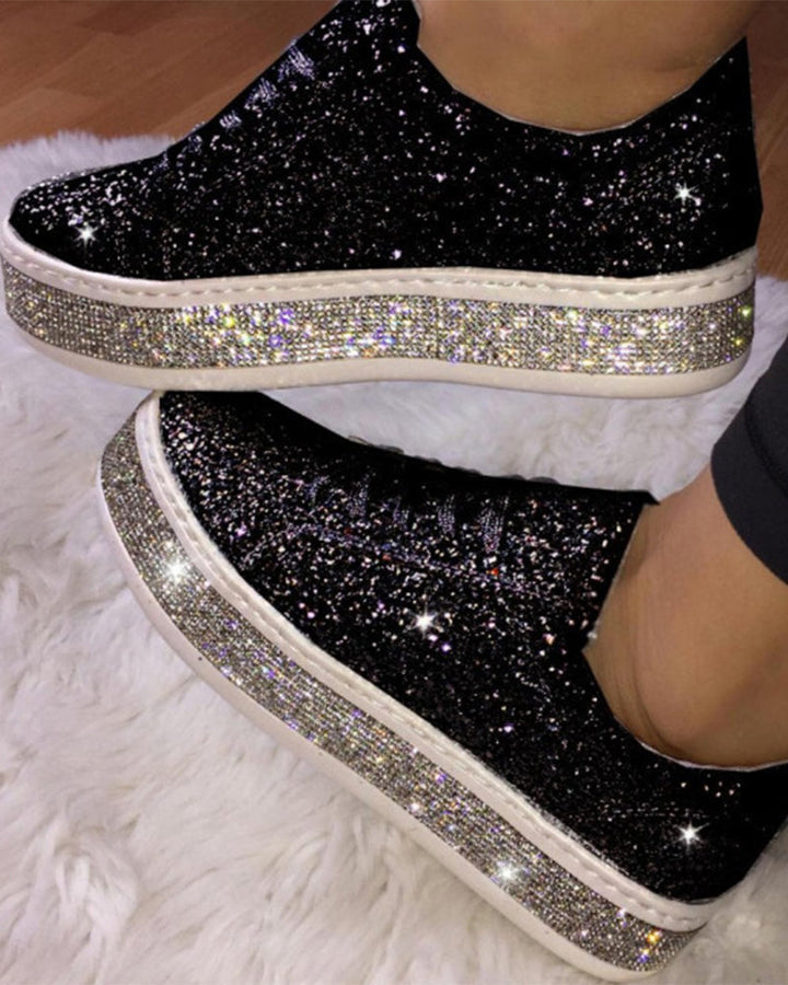 Stylish women's platform sneakers with shimmering glitter details. Comfortable footwear for street style.