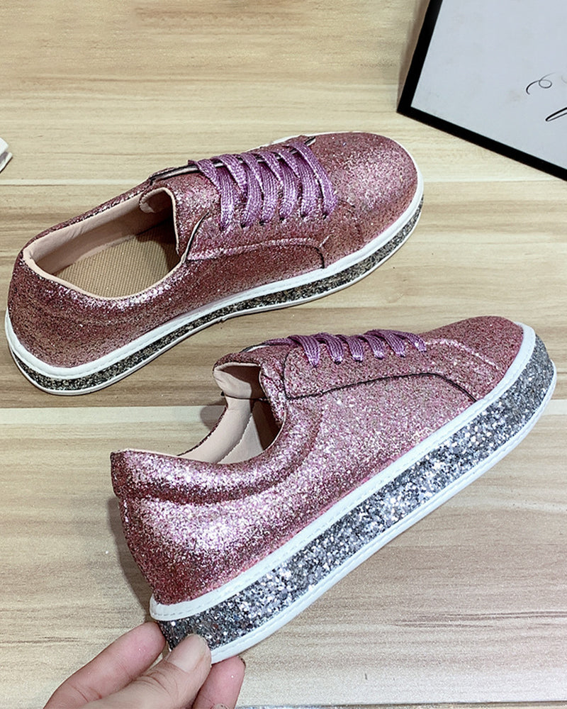 Pair of women's glitter platform sneakers from above. Trendy casual shoes with a comfortable platform.