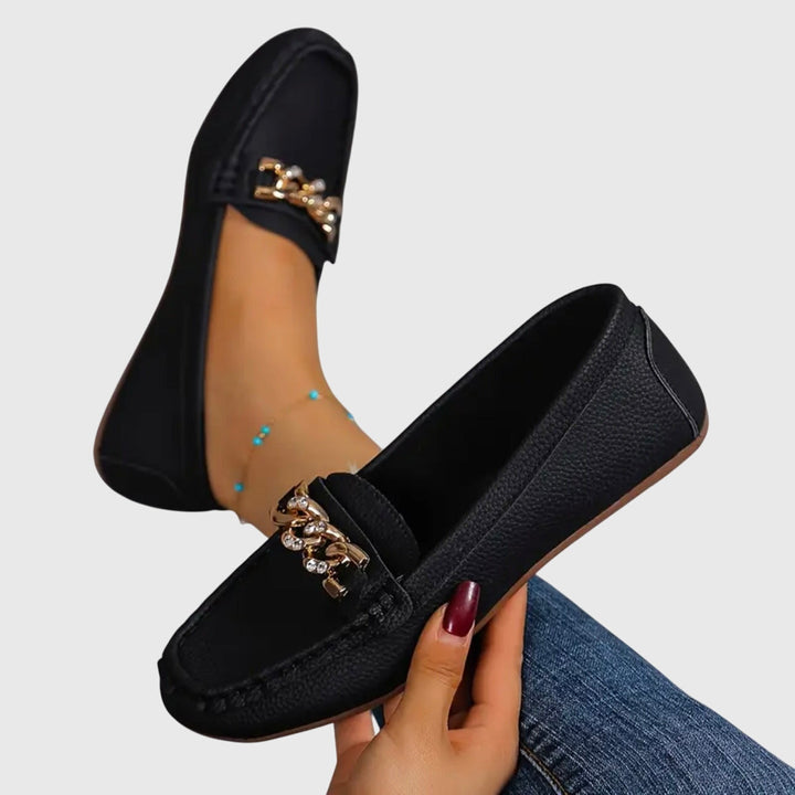 Women's designer-inspired wedge loafers with ornate gold chain and elegant crystal accents.