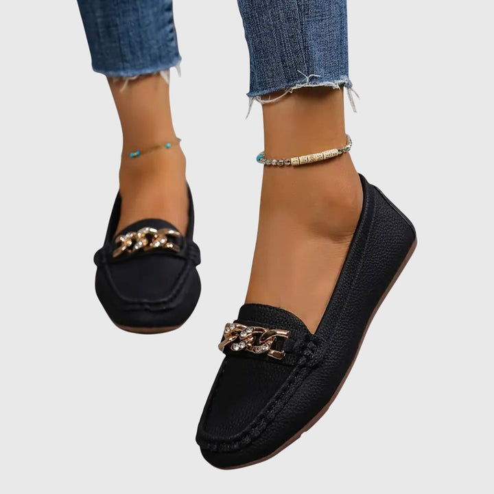 Elegant women's slip-on loafers featuring a stylish gold chain and crystal detail.