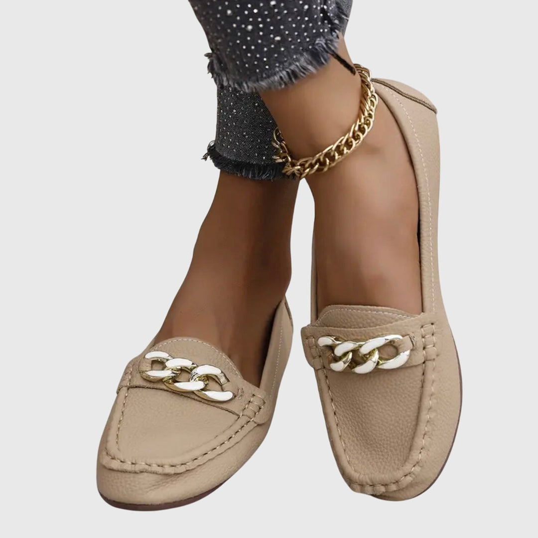 Fashion-forward women's loafers with a comfortable wedge heel, gold chain, & crystal accents.