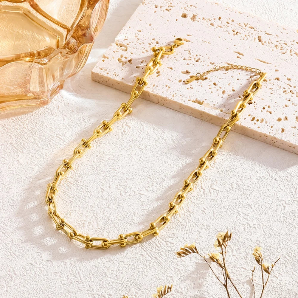 Versatile gold link chain necklace & bracelet for women, layered for style. Gold-plated stainless steel jewelry.
