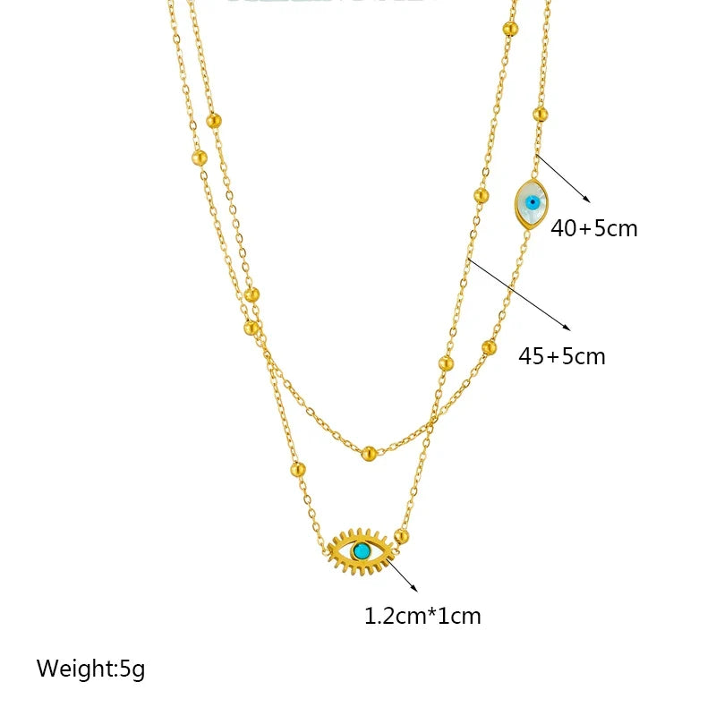 Close-up of a women's gold layered evil eye protection necklace, featuring delicate pendants and durable stainless steel.