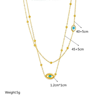 Close-up of a women's gold layered evil eye protection necklace, featuring delicate pendants and durable stainless steel.
