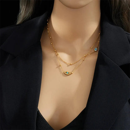 Elegant women's gold layered evil eye necklace for protection, crafted from high-quality stainless steel, a trendy jewelry item.