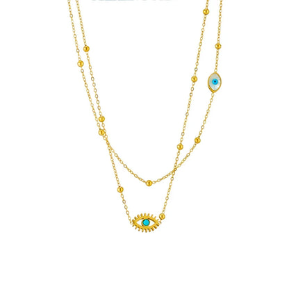 Stylish women's evil eye pendant necklace in gold, a layered protection jewelry piece made from durable stainless steel.