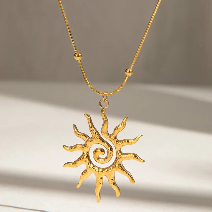 Elegant women's sun charm necklace in gold-plated stainless steel, a chic bohemian jewelry accessory.