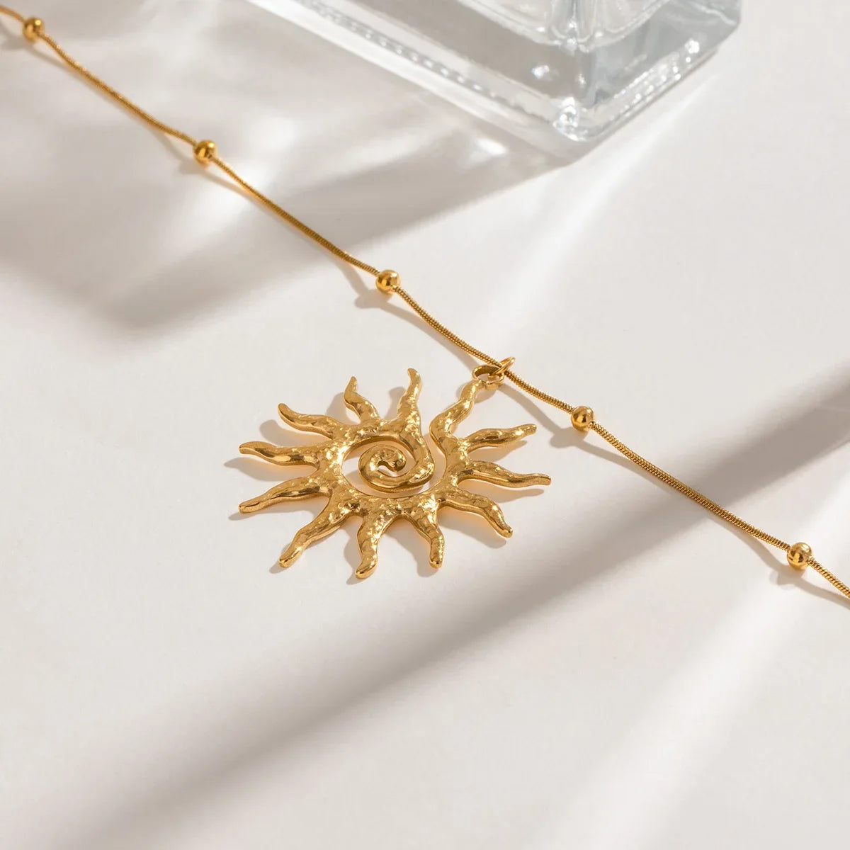 Women's bohemian sun charm necklace, gold-toned stainless steel jewelry for an elegant, everyday look.