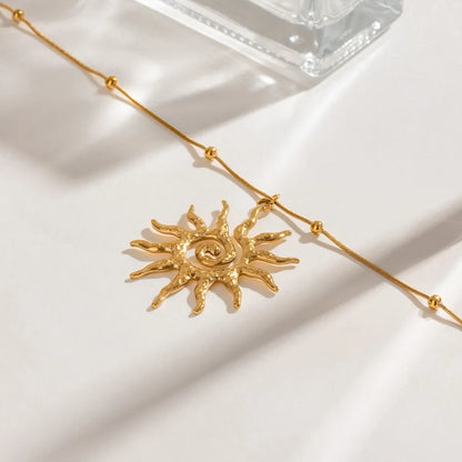 Women's bohemian sun charm necklace, gold-toned stainless steel jewelry for an elegant, everyday look.