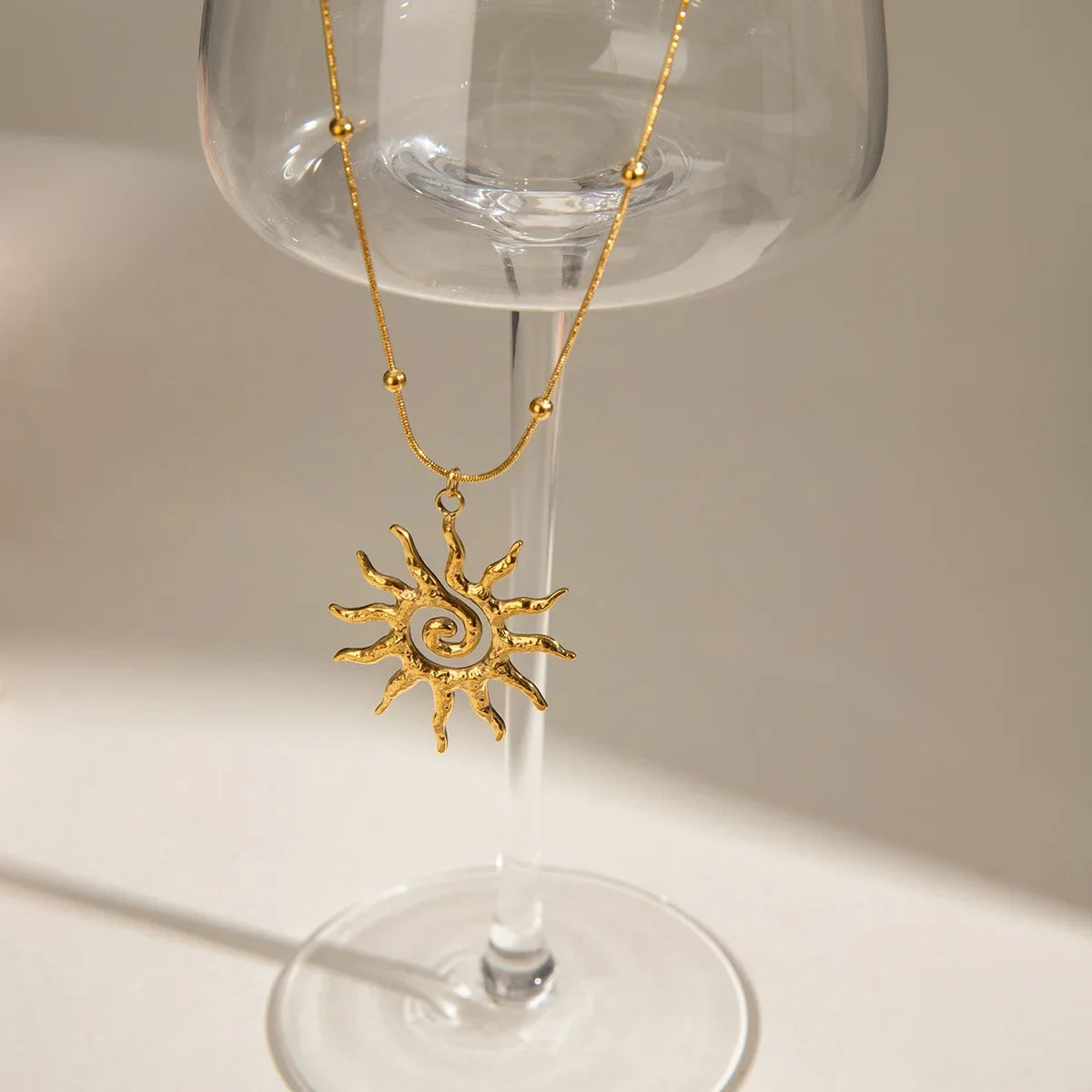 Dainty gold sun charm necklace for women, bohemian style, crafted from adjustable stainless steel jewelry.