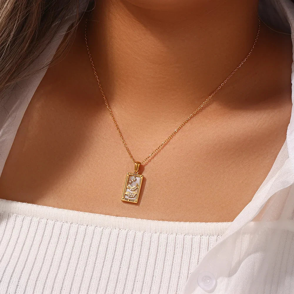 Close-up of a women's gold-plated tarot card pendant necklace, detailed mystical jewelry.