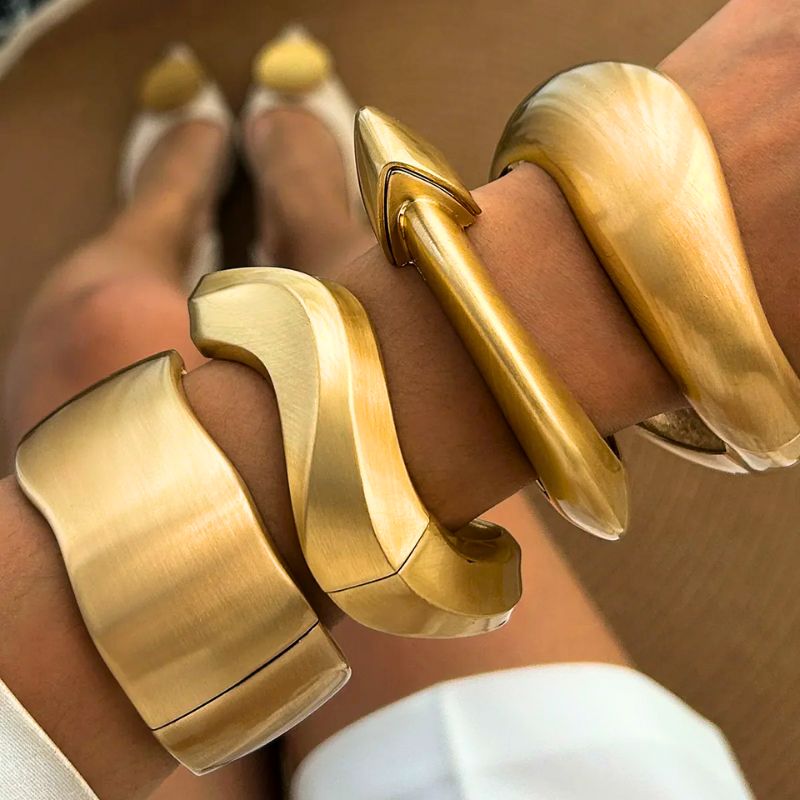 Shiny gold tone wave cuff bangles for women. A trendy 4-piece set, perfect for stacking & fashion.