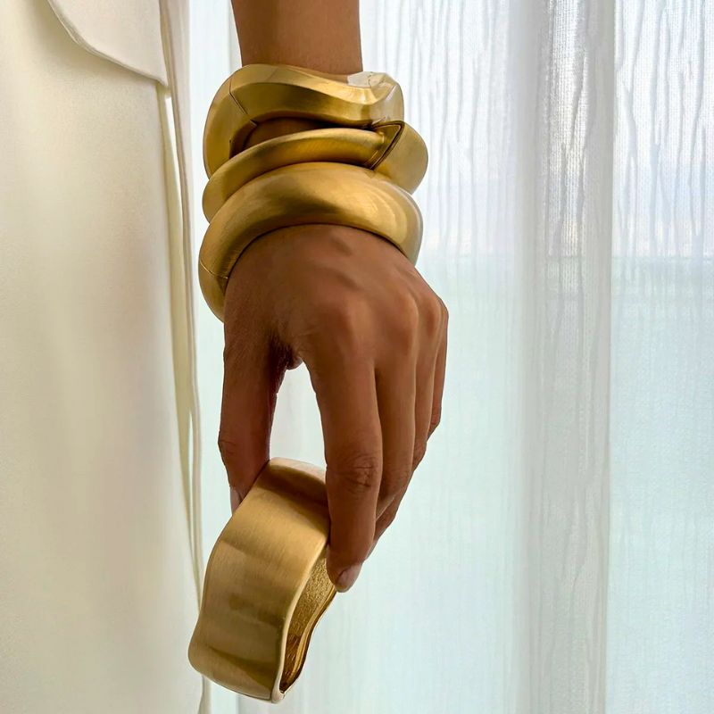 Elegant women's gold tone wave cuff bracelets. 4-piece stackable set, ideal vintage style fashion accessory gift.