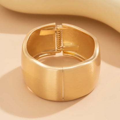 Fashionable women's gold tone wave cuff bracelets. 4-piece stackable set, vintage-inspired bangles for everyday style.