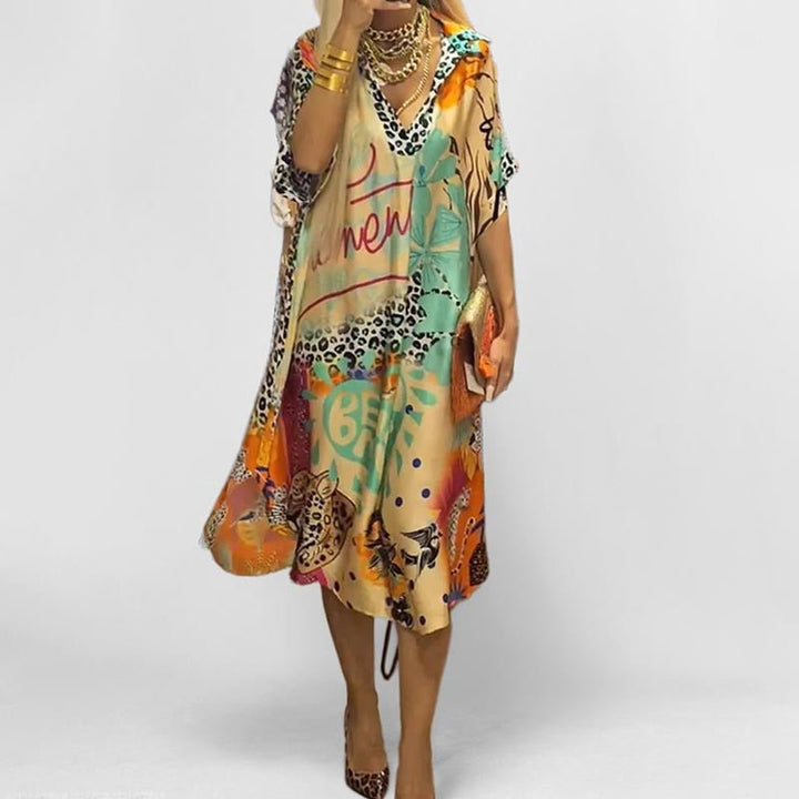 Women's graphic print swing tunic dress with V-neck, short sleeves. Perfect casual summer day dress or beachwear.