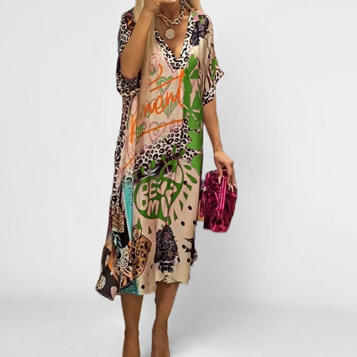 Relaxed fit V-neck graphic print tunic dress for women. Short sleeve swing style, ideal for vacation or casual summer.