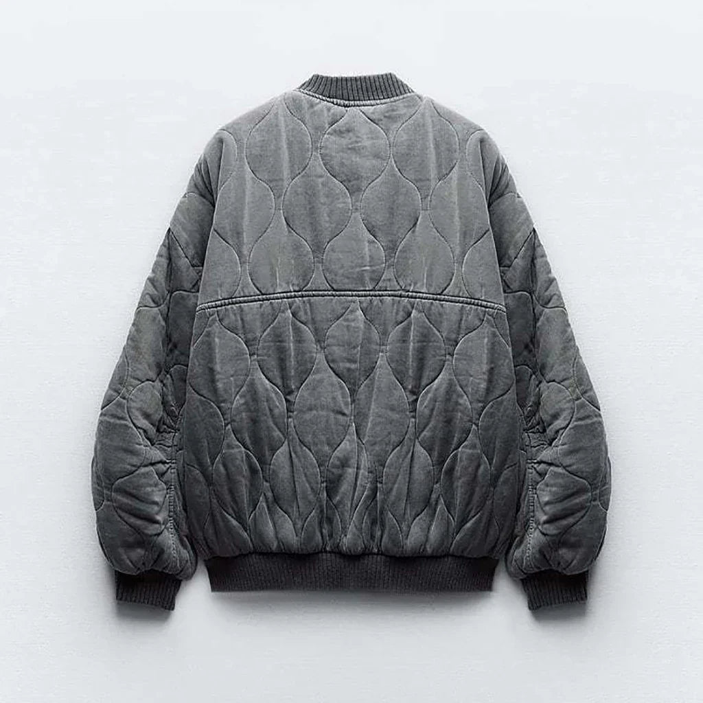 Versatile women's quilted bomber jacket in gray, perfect for casual modern style. Cozy fall fashion.