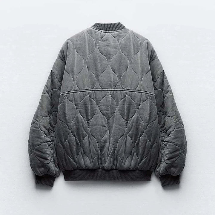 Versatile women's quilted bomber jacket in gray, perfect for casual modern style. Cozy fall fashion.
