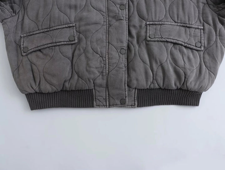 Women's modern gray quilted bomber jacket. Cozy and chic outerwear, perfect for everyday fall & winter style.