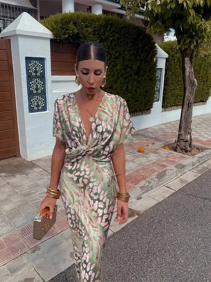 Flowy green wrap midi dress for women featuring a stylish abstract print & comfortable relaxed fit. Summer elegance.