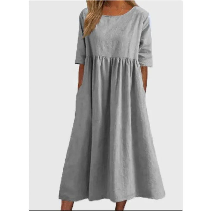 Versatile women's half-sleeve maxi dress with pockets, offering freedom of movement for casual or elegant occasions.