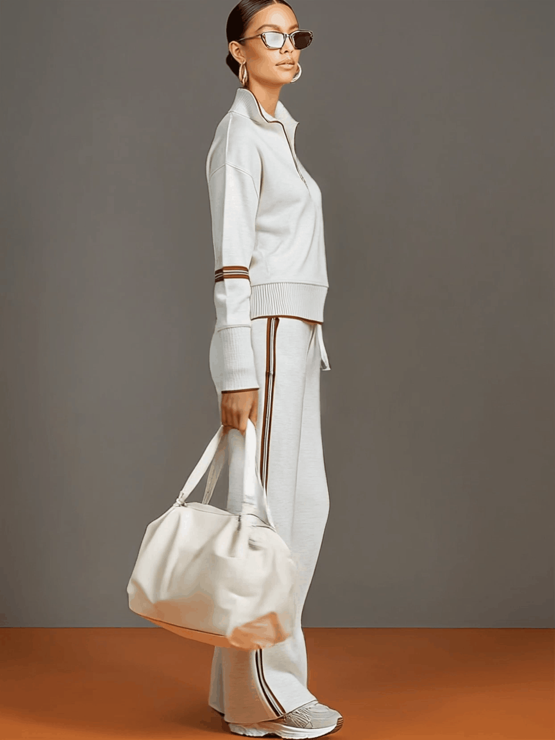 Modern athleisure co-ord: Women's half-zip sweatshirt and wide-leg trousers. Relaxed fit.