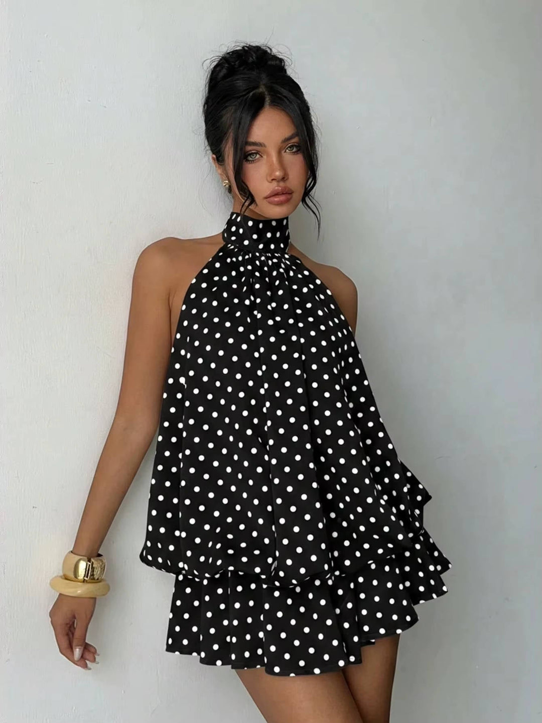 Must-have women's elegant halter mini dress, showcasing a pretty ruffle hem and sophisticated open back.
