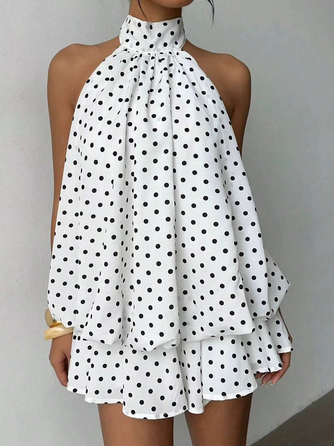 Glamorous women's trapeze style halter dress, perfect for parties with its ruffle hem and open back.