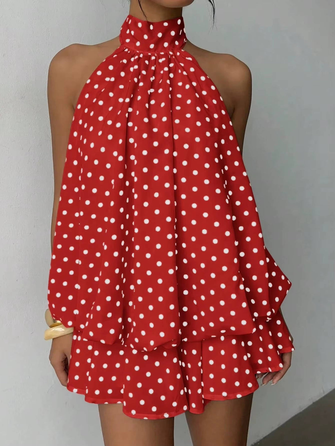 Women's elegant halter mini dress, sleeveless, with a fashionable ruffle hem and daring open back.