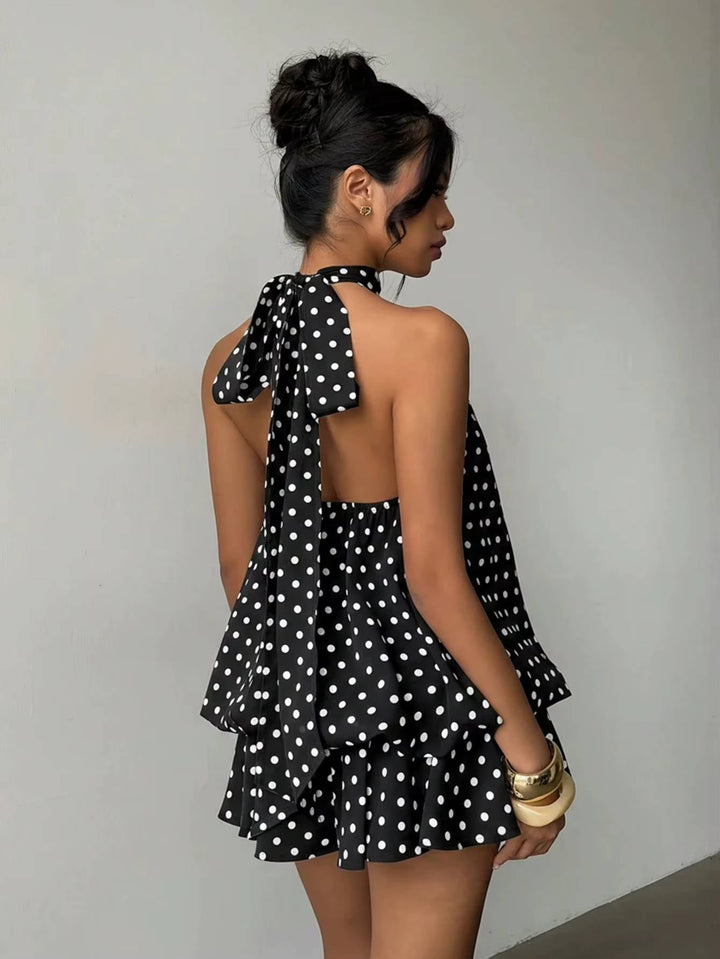 Modern women's mini dress for summer, featuring a halter neck, playful ruffle hem, and open back.