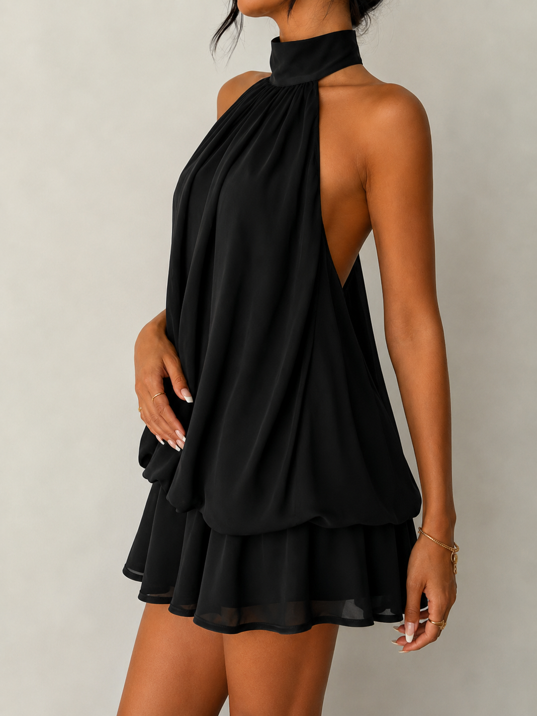 Versatile women's halter dress with a short, flowy ruffle hem and captivating open back for events.