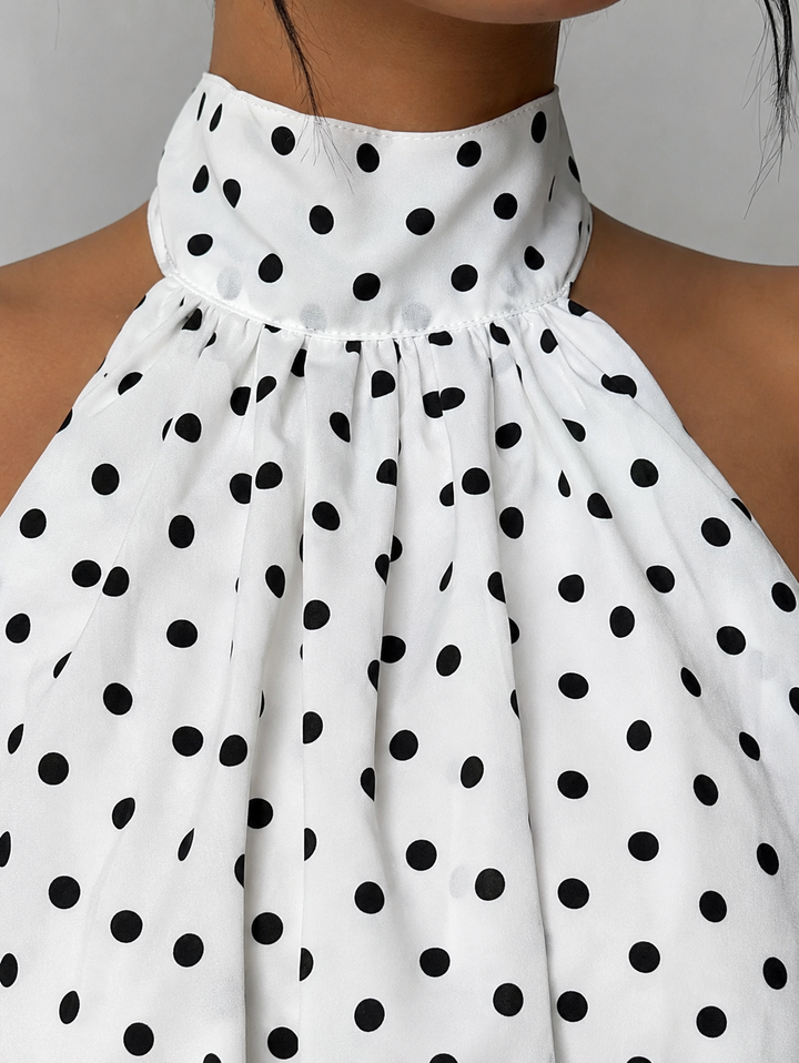 Elegant women's halter mini dress, featuring a stylish ruffle hem and alluring open back design.