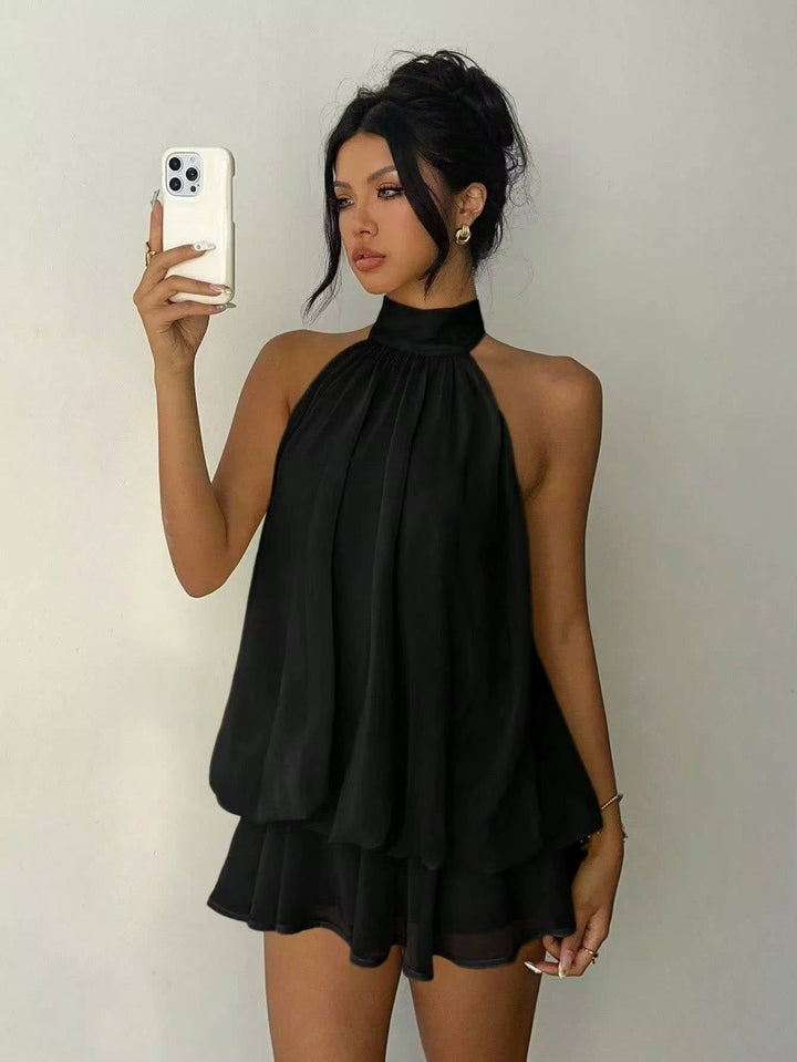 Women's party wear halter mini dress with an elegant ruffle hem and stunning open back. Cocktail ready.