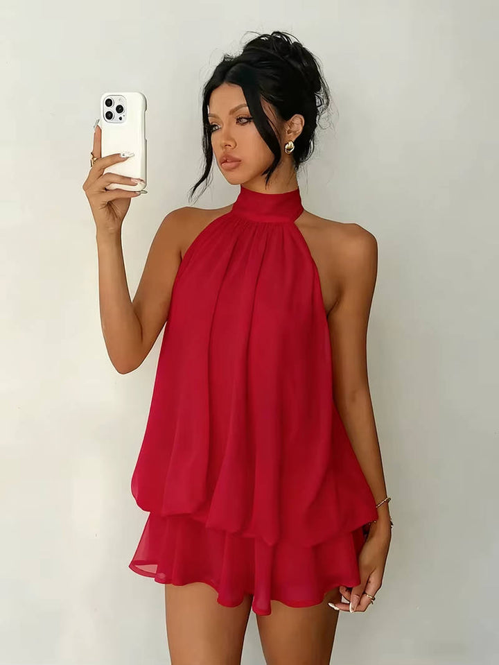 Party-ready women's halter mini dress featuring a playful ruffle hem, sleeveless, and open back.