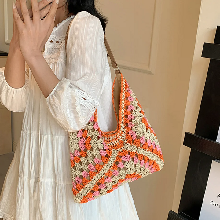 Stylish boho hand-crocheted shoulder bag, lightweight women's summer accessory.
