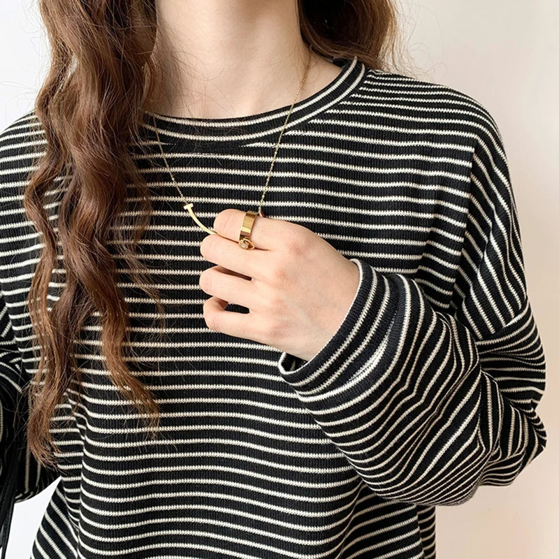 Versatile women's relaxed top with heritage stripes. Long sleeve, crewneck, ideal for casual layering.