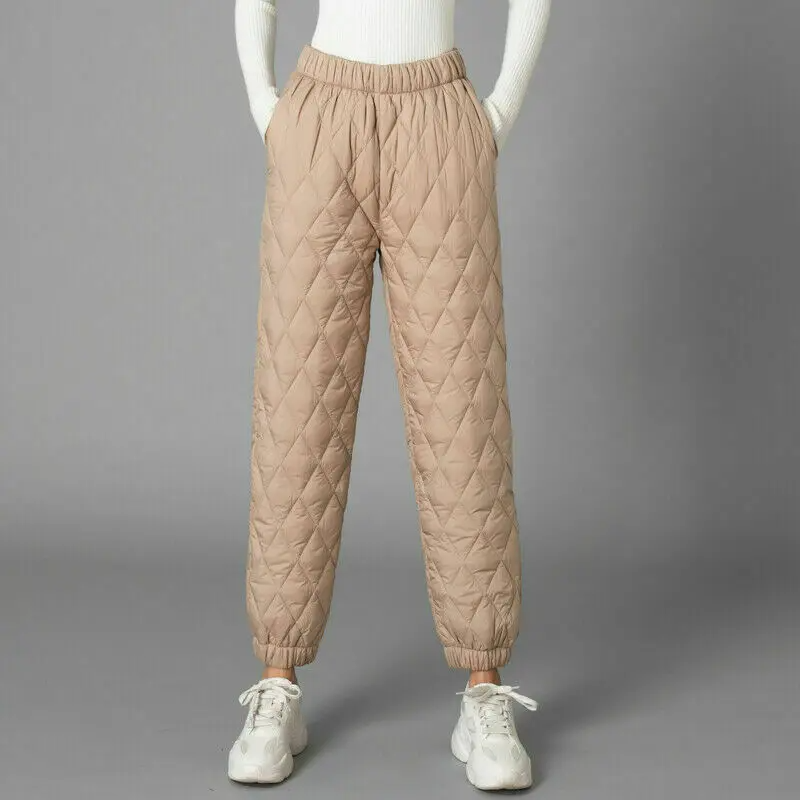 Woman models comfortable high-rise puffer joggers, great for winter loungewear & casual style.