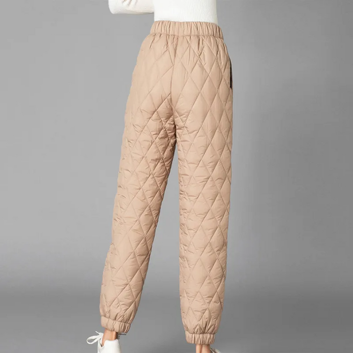 Close-up of soft, warm women's high-rise puffer jogger fabric with stretch waist detail.