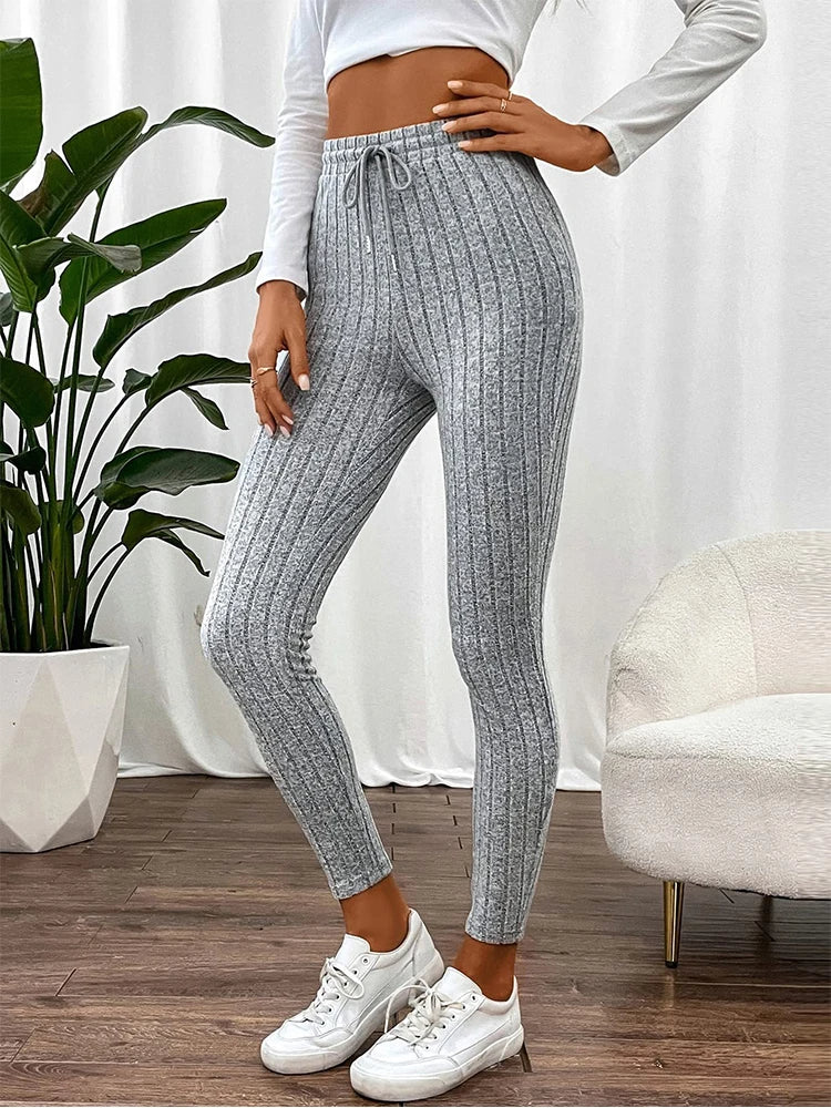 Detail shot of the comfortable high-rise waistband on women's ribbed stretch leggings, ensuring a secure fit.