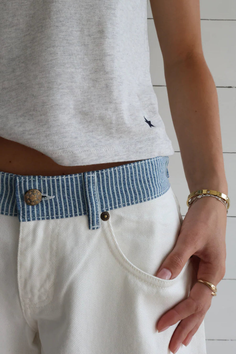 Woman wearing stylish high-rise wide-leg denim jeans, perfect for a chic, comfortable everyday look.