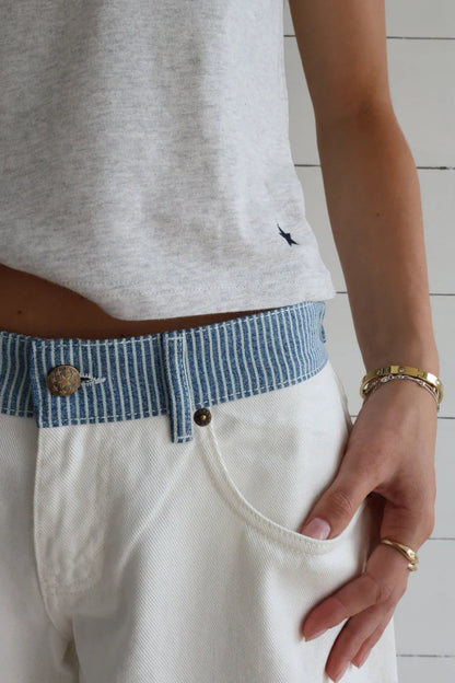 Woman wearing stylish high-rise wide-leg denim jeans, perfect for a chic, comfortable everyday look.